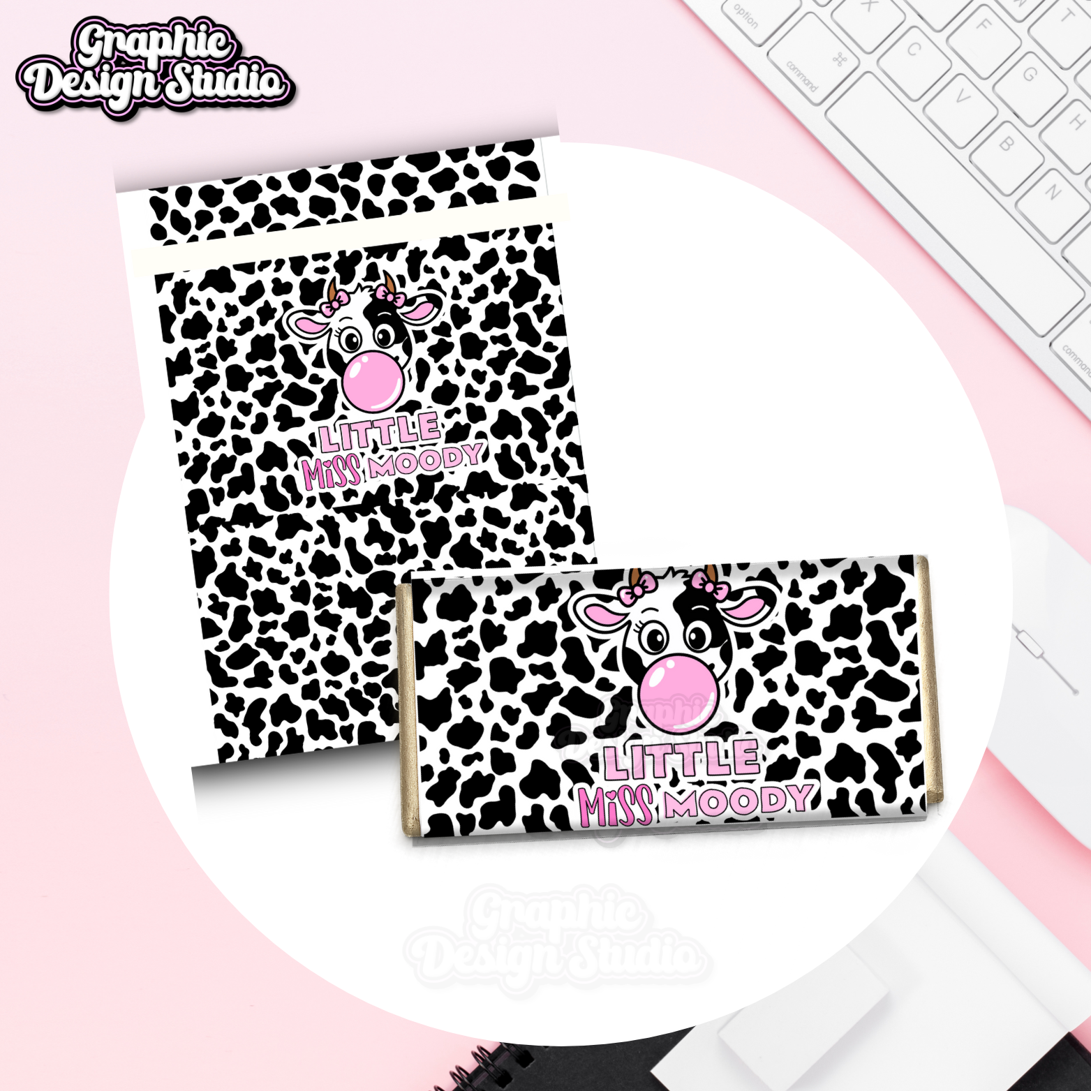 Two cow-themed packages with 'Little Miss Moody' text on a pink surface.