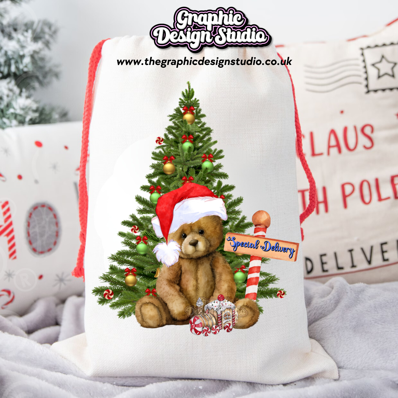 Decorative sack with a teddy bear wearing a Santa hat and Christmas tree design, featuring 'The Graphic Design Studio' logo.