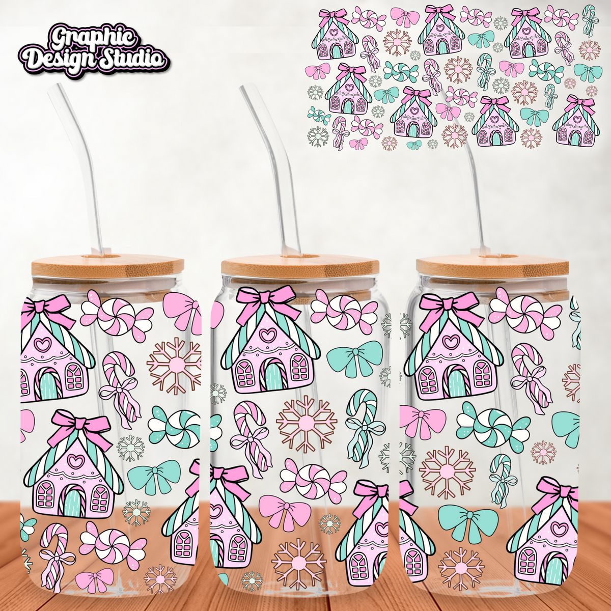 Three clear tumblers with gingerbread house design on a wooden surface.