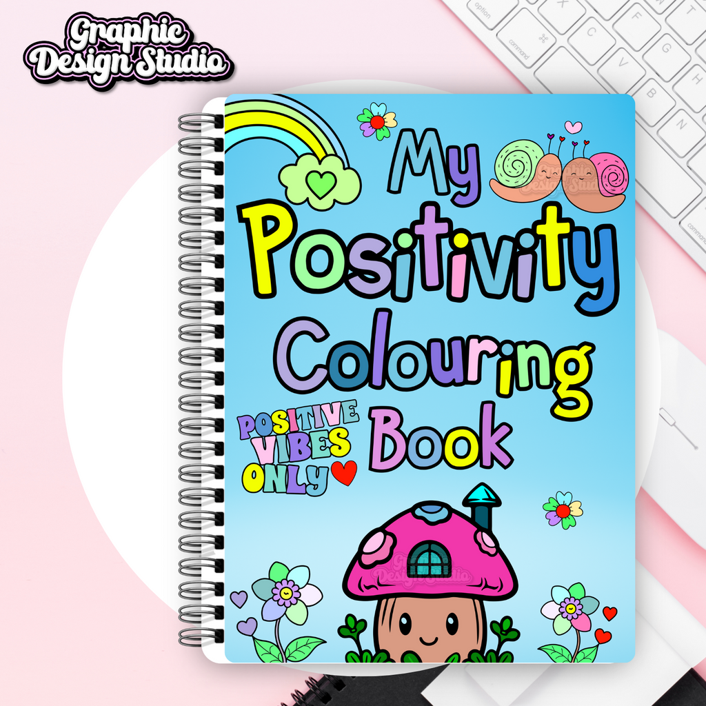 A notebook in multicolours, with my positivity colouring book on 