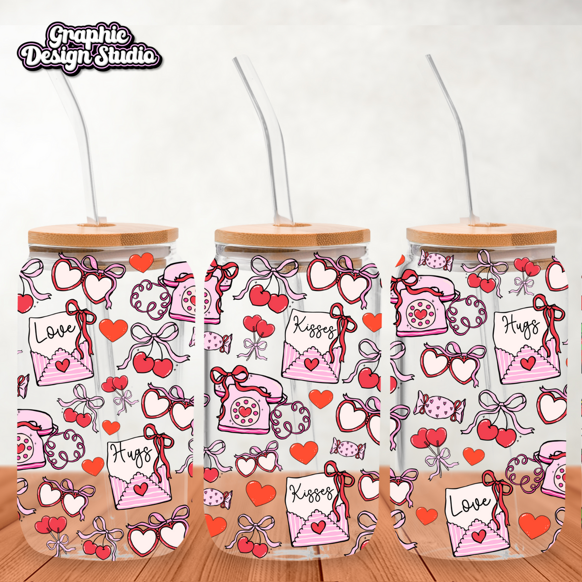 Three glass tumblers with decorative patterns on a wooden surface.
