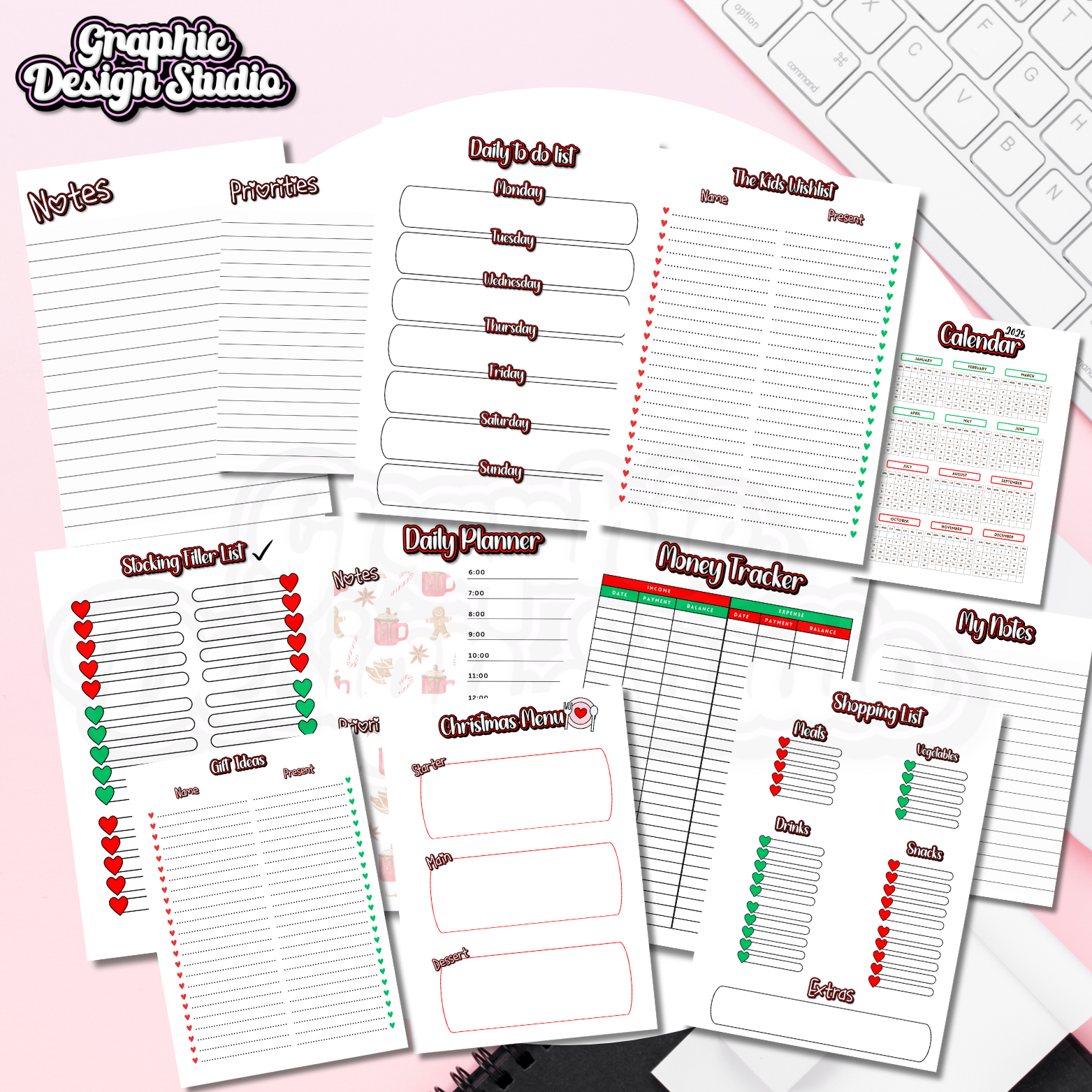 Collection of planner sheets on a pink surface with a keyboard in the background.